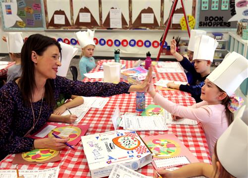 kaci high fives with student 